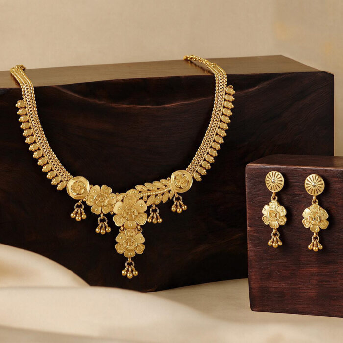 alt="curved petal floral temple necklace gold plated"