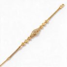 alt="floral medallion gold bracelet"