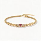 alt="triple heart studded gold bracelet"