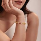 alt="triple heart studded gold bracelet"