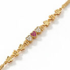 alt="triple heart studded gold bracelet"
